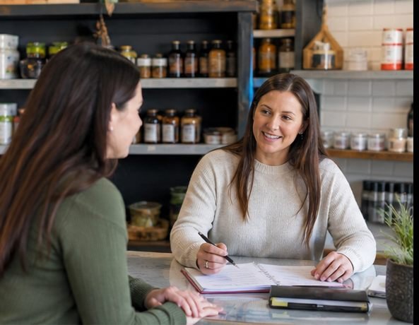 Bookkeeping professional meeting a local small business owner at their workplace in Idaho